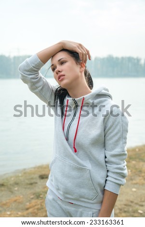 Portrait of a young sad woman  with headache, fatigue or cold. Depression, stress, illness concept.