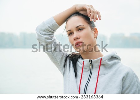 Portrait of a young sad woman  with headache, fatigue or cold. Depression, stress, illness concept.