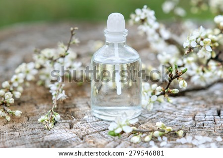 Spa and wellness setting with sea salt, oil essence, flowers and towels on wooden background. Relax and treatment therapy. Manicure and pedicure settings.  Spring season. Selective focus. Close up.
