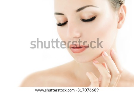 Beauty Model with  Perfect Fresh Skin and Long Eyelashes. Youth and Skin Care Concept. Spa and Wellness. Make up and Hair. Lashes. Close up, selected focus.