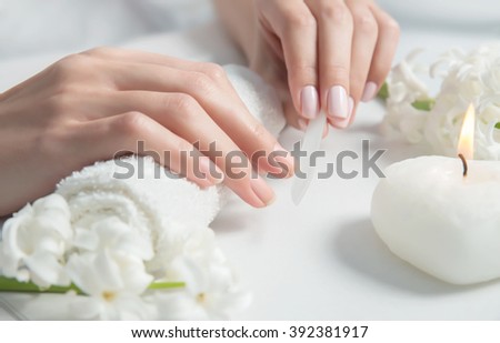 Woman getting nail manicure. Close up, selective focus.