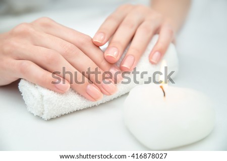 Woman getting nail manicure. Close up, selective focus.