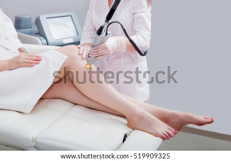 Laser epilation and cosmetology.at cosmetic beauty spa clinic. Hair removal cosmetology procedure from a therapist. Cosmetology and SPA concept.