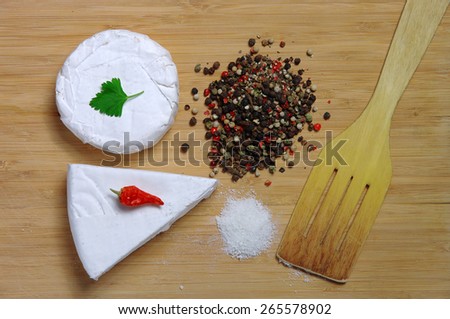 cheese on a table next to a variety of ingredients for cooking