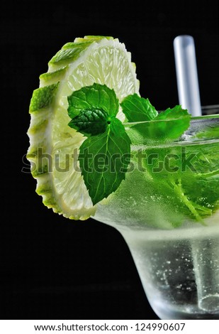 Alcohol cocktail drink with lemon, isolated black background