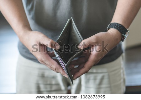 bankruptcy economic financial concept. Person open his empty wallet without money to pay debt in payday.