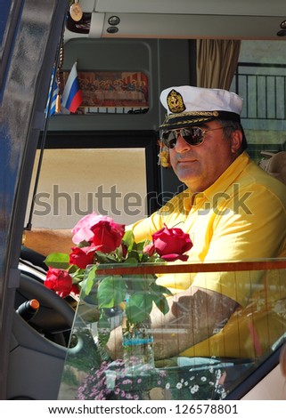 HALKIDIKI, GREECE - APRIL 27: The Greek driver of modern bus for tourists transportation on April 27, 2012 in Halkidiki, Greece. 11,3 million tourists have visited Greece in year 2012