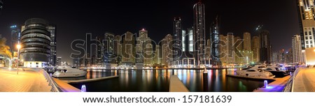 DUBAI, UAE - SEPTEMBER 8: The night illumination of Dubai Marina on September 8, 2013 in Dubai, UAE. It is an artificial canal city, built along a two mile (3 km) stretch of Persian Gulf shoreline.