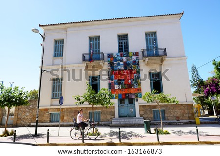 KALAMATA, GREECE - JUNE 7: The building with paintings and cyclist on June 7, 2013 in Kalamata city, Messinia, Greece. Up to 16 mln tourists is expected to visit Greece in year 2013.