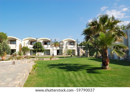 Palm tree on the lawn at luxury hotel, Crete, Greece
