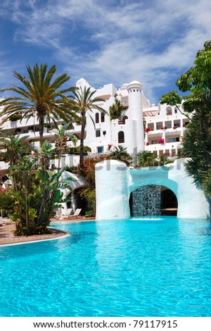 Swimming pool with waterfall and building of luxury hotel, Tenerife island, Spain