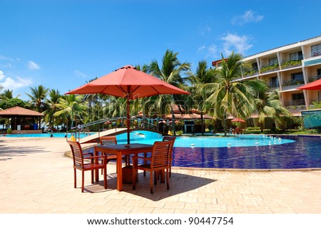 The table and chairs of outdoor restaurant near  swimming pool at luxury hotel, Bentota, Sri Lanka