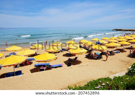 CRETE, GREECE - MAY 12: The tourists enjoiying their vacation on the beach on May 12, 2014 in Crete, Greece. Up to 16 mln tourists is expected to visit Greece in year 2014.