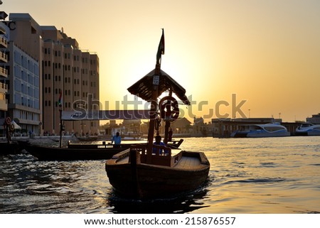 DUBAI, UAE - SEPTEMBER 10: The traditional Abra boat in Dubai Creek on September 10, 2013 in Dubai, United Arab Emirates. The Abra is cheapest transport in Dubai