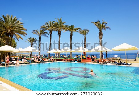 BUGIBBA, MALTA - APRIL 23: The tourists are on vacation at popular hotel on April 23, 2015 in Bugibba, Malta. More then 1,6 mln tourists is expected to visit Malta in year 2015.