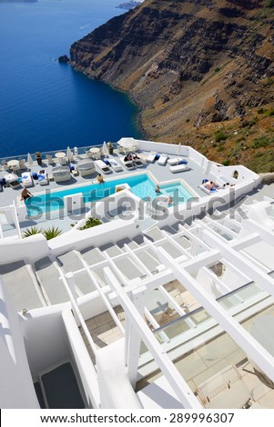 OIA, GREECE - MAY 17: The tourists enjoying their vacation at luxury hotel on May 17, 2014 in Oia, Greece. Up to 16 mln tourists is expected to visit Greece in year 2014.
