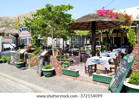 KAMARI, SANTORINI ISLAND, GREECE - MAY 19: The outdoor restaurant near beach on May 19, 2014 in Kamari, Santorini island, Greece. Up to 16 mln tourists is expected to visit Greece in year 2014.
