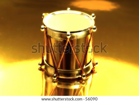 Photo of a Drum Chirstmas Ornament on GOld Surface.