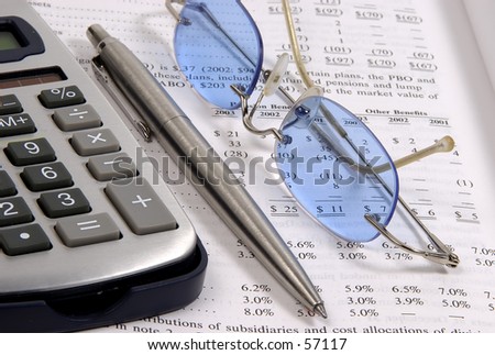 Photo of a Calculator, Glasses, Pen and Paper