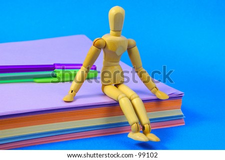 Mannequin Sitting on Colored Paper