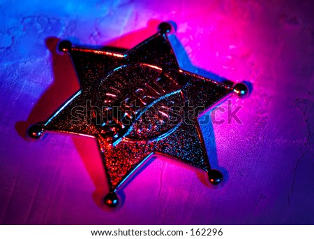 Sheriffs Badge With Colored Gel Lighting. See Portfolio For Similar Concepts