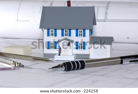 Miniature House With Various Drafting Items and Blue Prints.  See Portfolio For Similar Concepts.