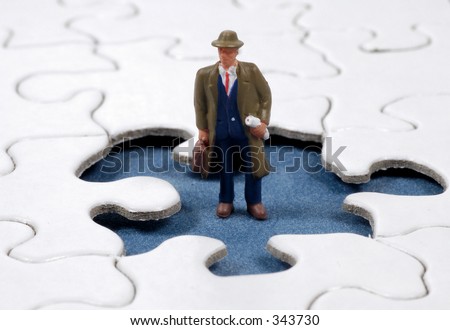 Miniature Man Standing on a Puzzle Piece