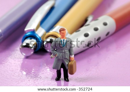 Miniature Business Man With pens In Background