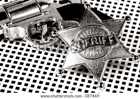 Pistol and Sheriffs Badge