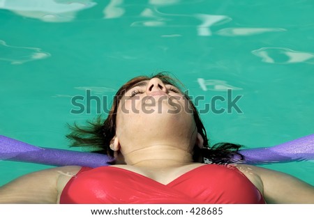 Woman Floating in a Pool