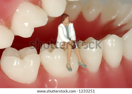 Miniature Woman Sitting on Teeth
