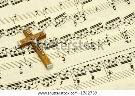 Crucifix on top of Sheet Music