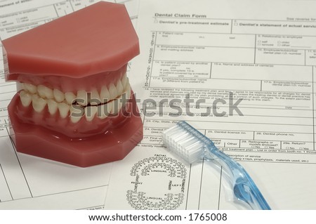 Photo of Dental Claim Forms and Model of Teeth - Dental Claim Concept