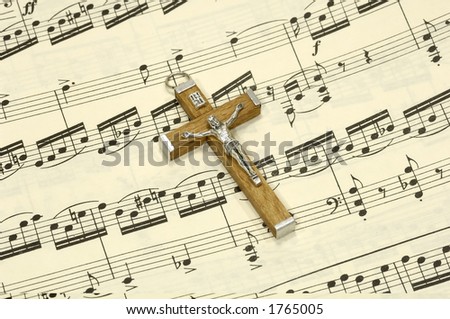 Crucifix on top of Sheet Music