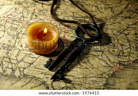 Photo of a Vintage Map with a Candle and Treasure Key