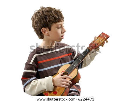 Photo of a Child Holding a Musical Instrument / Ukulele - Music Related