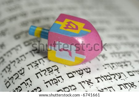 Dreidel with Gelt and a Hebrew Bible - Passover Related