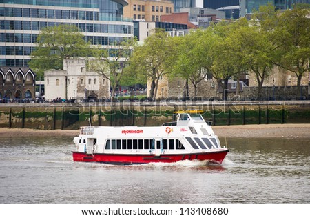 LONDON-MAY 21: A City Cruises tour boat sails on the Thames River on May 21, 2013 in London, England. Thames is the longest river in England with 346 km (215 miles) long.
