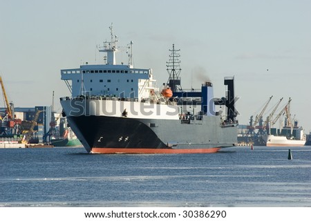 Cargo ship in harbor (logos and brandnames systematically removed)