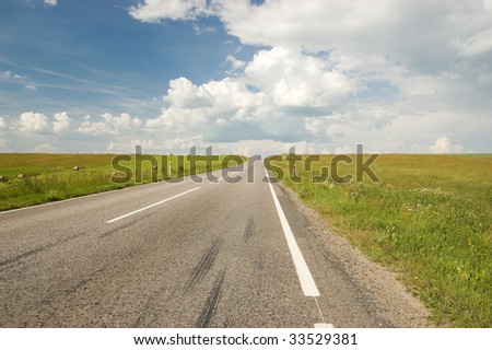 Empty land road with blue sky and clouds