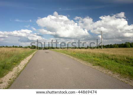 empty land road with deep blue sky and clouds