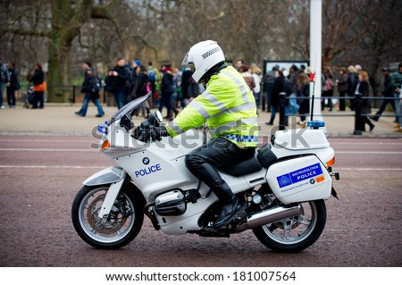 LONDON - FEB 17: Special Escort Group Police motorcyclist on the street near Buckingham Palace on Feb. 17, 2012 in London, UK. The unit provides motorcycle escorts for members of the Royal family.