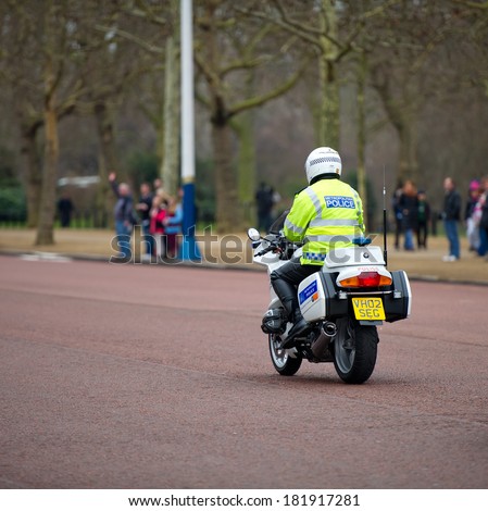 LONDON - FEB 17: Special Escort Group Police motorcyclist on the street near Buckingham Palace on Feb. 17, 2012 in London, UK. The unit provides motorcycle escorts for members of the Royal family.