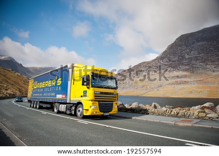 SNOWDONIA, UK - MAR 25: DAF XF truck on a road on Mar. 25, 2014 in Snowdonia, Wales, UK. The DAF XF is a range of trucks produced by the Dutch manufacturer DAF since 1997.
