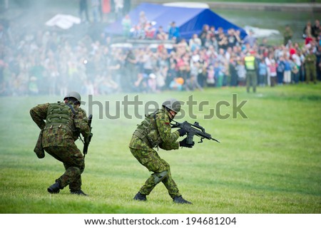 VILNIUS - MAY 17: In a combined air-ground operation, a joint Lithuanian military force demonstrating their mastership during Public and Military Day Festival on May 17, 2014 in Vilnius, Lithuania