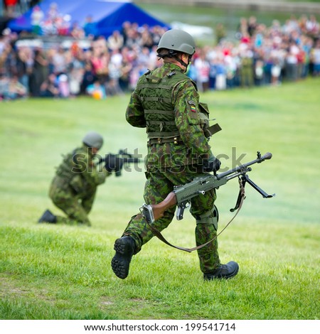 VILNIUS - MAY 17: In a combined air-ground operation, a joint Lithuanian military force demonstrating their mastership during Public and Military Day Festival on May 17, 2014 in Vilnius, Lithuania.
