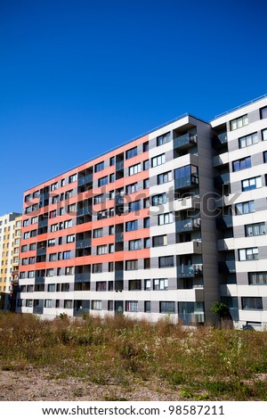 Modern and new apartment building. Multistoried, modern, new and stylish living block of flats. Real estate. New house. Newly built block of flats