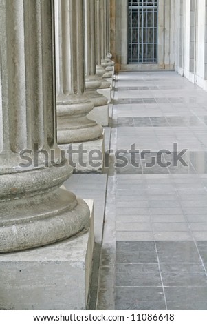 Law and order justice pillars outside a courthouse made of stone