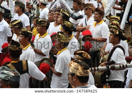 DENPASAR, INDONESIA - MAY 12:  Local village men in traditional funeral dress watch the preparations for a Ngaben or cremation ceremony in Ubud, Denpasar, Bali, Indonesia on May 12, 2013.