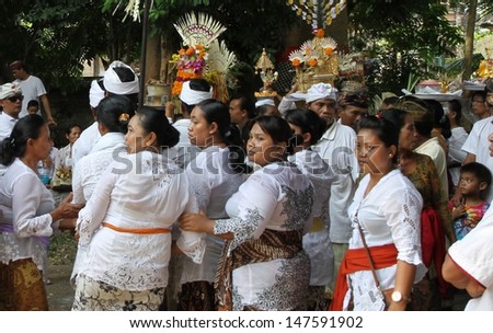 DENPASAR, INDONESIA - MAY 12:  Local village women watch the preparations for a Ngaben or cremation ceremony in Ubud, Denpasar, Bali, Indonesia on May 12, 2013.